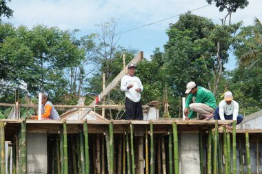 Workers are building a house