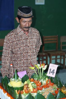 The judging process of the Tumpeng Competition in commemoration of the Indonesian Independence Day ( Tumpeng is a typical Indonesian food made of rice )
