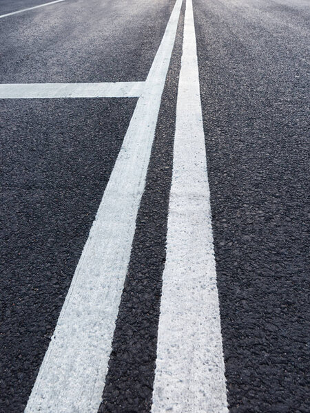 Asphalt road with white marking diminishing perspective