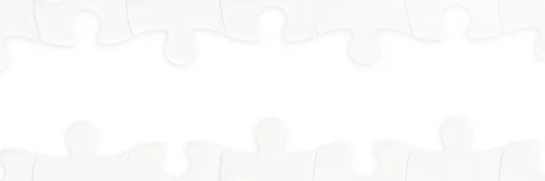White Jigsaw Puzzle Pieces Long Frame Isolated White Clipping Path lizenzfreie Stockbilder