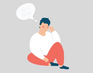 Young man sits on the floor and has anxiety. Stressed boy has confused thinking looks upset. Depressed adolescent male with tangled thoughts has psychological problem. Mental health disorders concept.