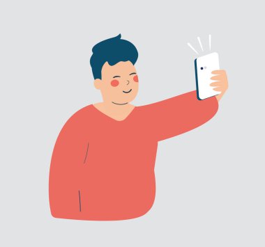 Genç adam akıllı telefonuyla selfie çekiyor. Sosyal medyaya bağımlı genç bir çocuk ve sanal arkadaşlarıyla video görüşmesi yapıyor. Telefon görüşmesi ve uzun mesafeli ilişkiler kavramı.
