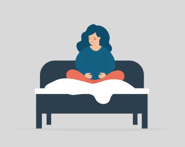 Pregnant wakes up, sits on her cozy bed and wearing pajamas. Woman expecting a baby gets up and touches her belly in the morning. Pregnancy breathing exercise, Positive mood and wellbeing concept.