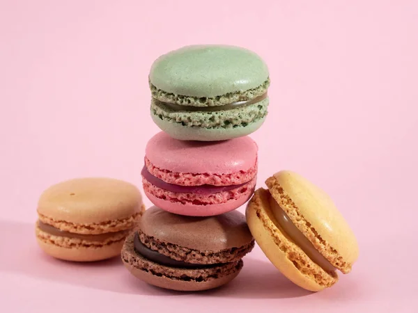 Colorful macarons on pink background — Stock Photo, Image