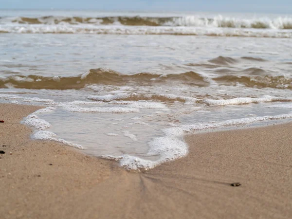 Onda com praia de costa espumosa branca. Costa arenosa. — Fotografia de Stock