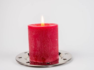 Beyaz arka planda kırmızı Noel mumu.