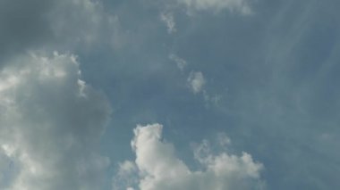 White clouds in the blue sky. Clouds float across the sky.