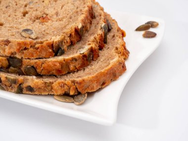 Beyaz arka planda kabak tohumlu ekmek. Balkabağı ekmeği.