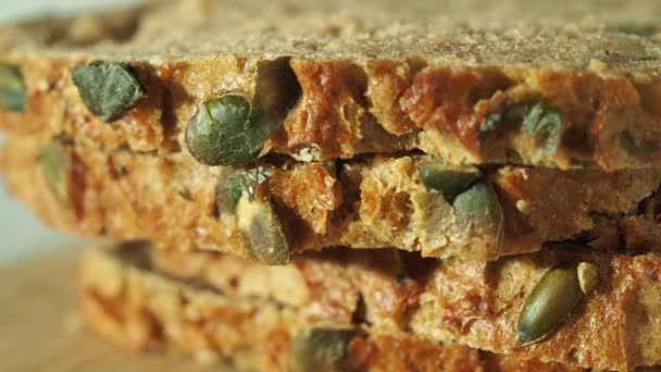 Bread with pumpkin seeds on a white background. Pumpkin bread. — Stockvideo