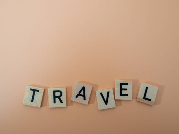 Inscription (Travel) in wooden letters, vacation and travel concept