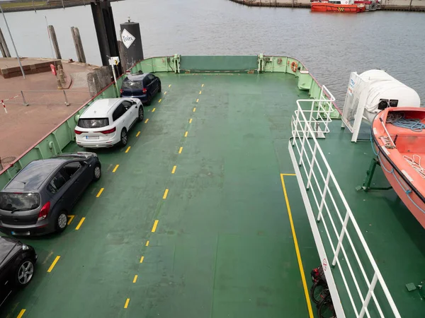 The barge transports cars and people. Barge for transportation.