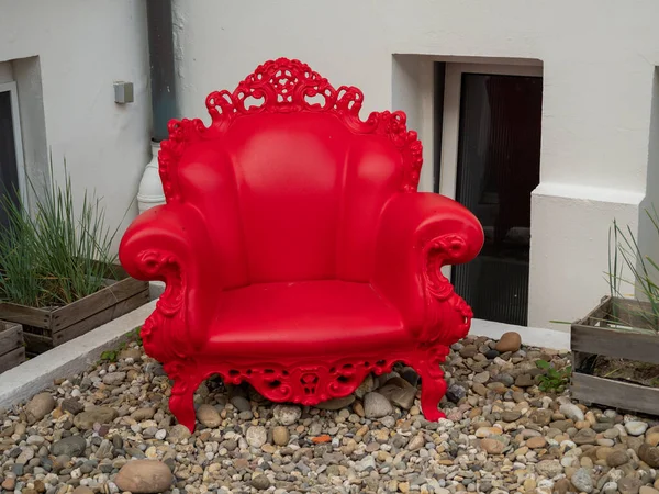 Red armchair at home. Red armchair against the wall of the house.