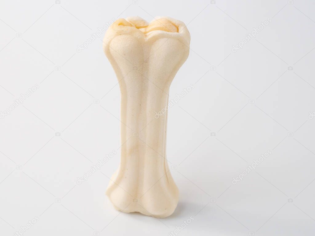 Pressed rawhide bone shaped dog chews isolated on a white background