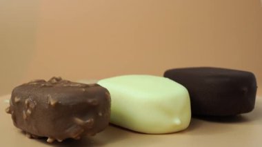 Different varieties on a stick. Ice cream on an orange background. High quality 4k footage