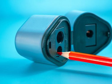 Education and back to school concept. Pencil and sharpener on a blue background.