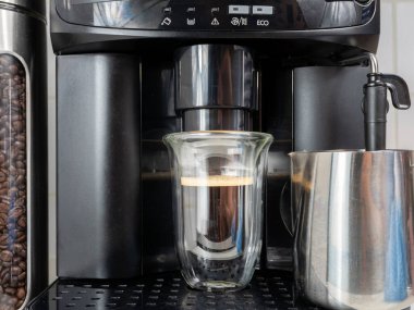 Kahve makinesinin cam bardakta hazırladığı taze kahve. Sade kahve.