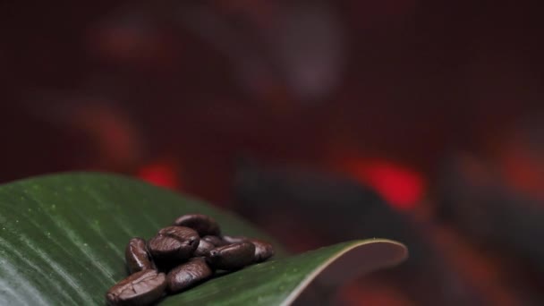 Coffee Beans Lie Green Leaf Background Fire Coffee Background — Stockvideo