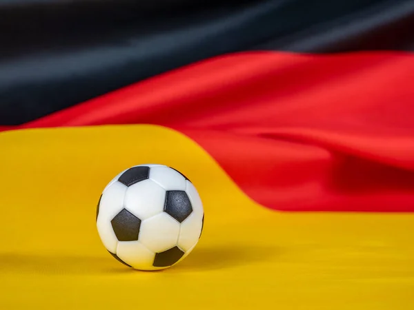 Soccer ball on the German flag. The ball against the background of the German flag. German football league concept.