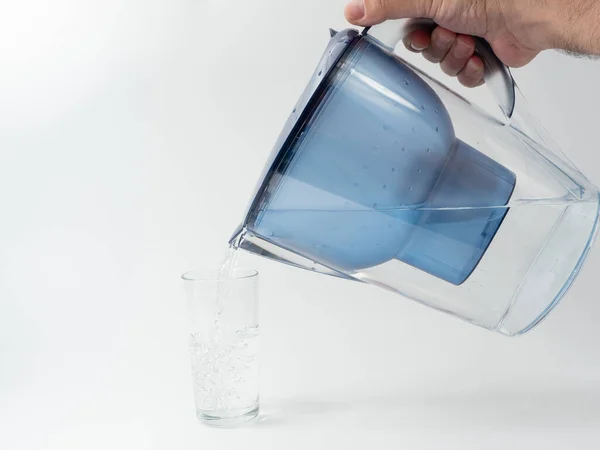 Jug with water filter made of transparent plastic. Drinking water filter.