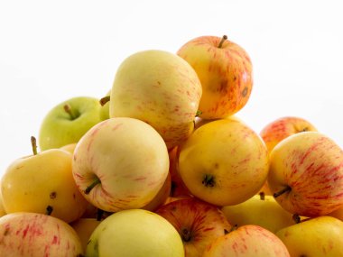 Fresh red apples on a wooden table with a white background. Apples from the garden.