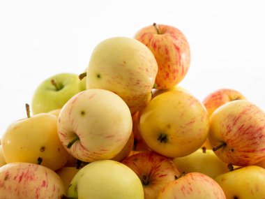 Fresh red apples on a wooden table with a white background. Apples from the garden.