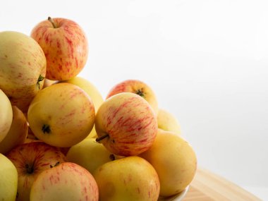 Fresh red apples on a wooden table with a white background. Apples from the garden.