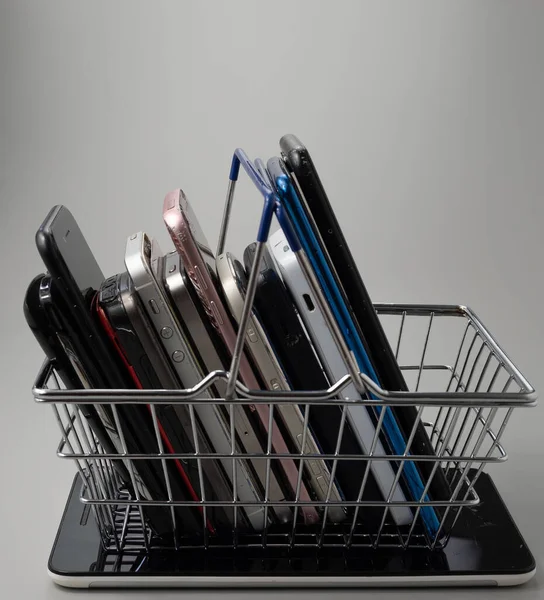 Phones Different Models Generations Shopping Cart Smartphones Gray Background — Fotografia de Stock