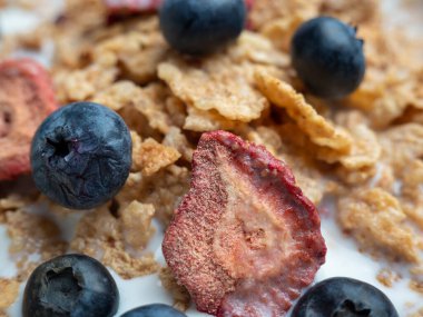 A cup with muesli and fresh berries on a wooden table. Healthy food, snack or breakfast. Healthy food.
