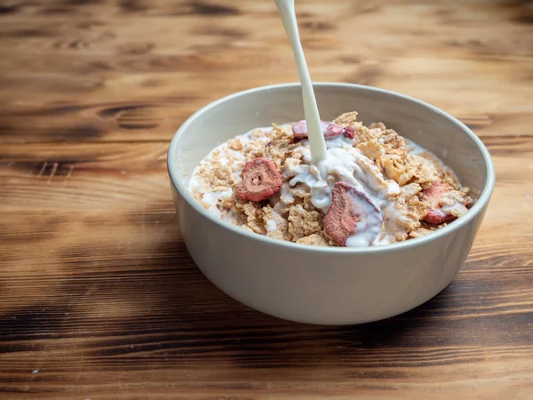 A cup with muesli and fresh berries on a wooden table. Healthy food, snack or breakfast. Healthy food.