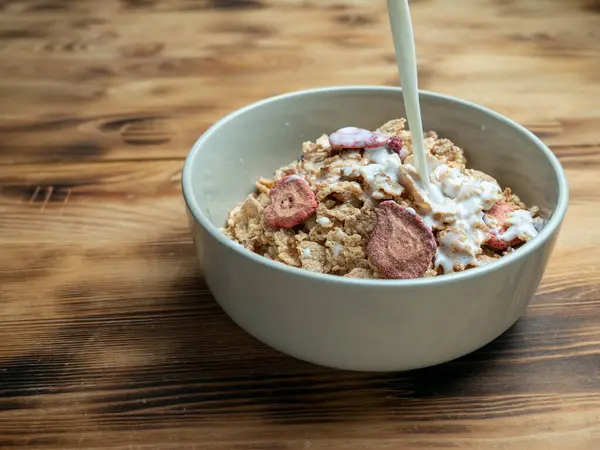 A cup with muesli and fresh berries on a wooden table. Healthy food, snack or breakfast. Healthy food.