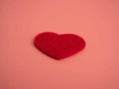 Red heart on a pink background. Close-up. Love concept.