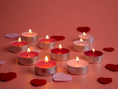 Pink candles on a pink background. Close-up. Love concept.