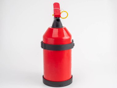 Red fire extinguisher on a white background. Fire extinguisher close up.
