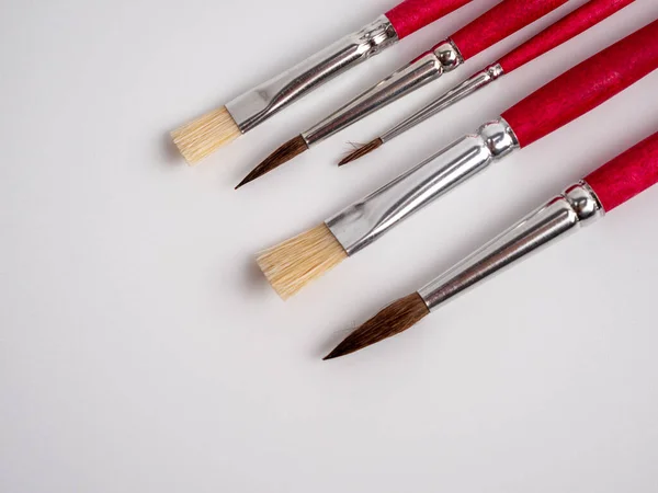 Various artist's brushes on a white background. Paint brushes.