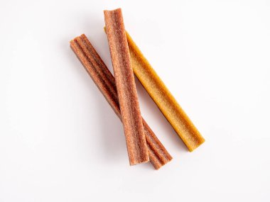 Close up dog tooth stick to reduce tartar buildup isolated on white. Canine dental sticks.