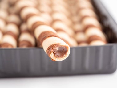 Chocolate wafer sticks or rolls, on a white background. Close-up.