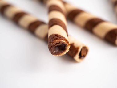Chocolate wafer sticks or rolls, on a white background. Close-up.