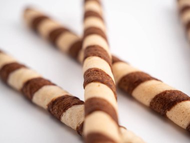 Chocolate wafer sticks or rolls, on a white background. Close-up.