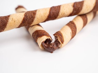 Chocolate wafer sticks or rolls, on a white background. Close-up.