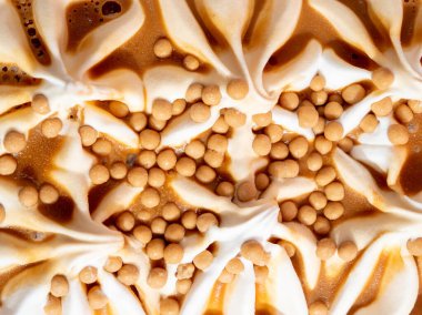 Caramel ice cream on a pink background. Ice cream closeup.