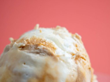 Caramel ice cream on a pink background. Ice cream closeup.