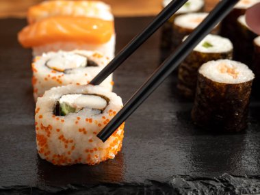 Japanese kitchen. Sushi on a dark background. Sushi close up.