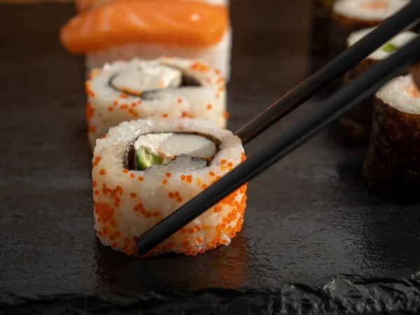 Japanese kitchen. Sushi on a dark background. Sushi close up.