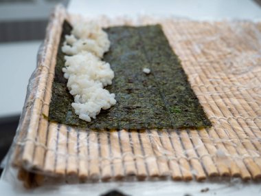 Sushi with fish and cucumber. Sushi is prepared at home. Close-up.
