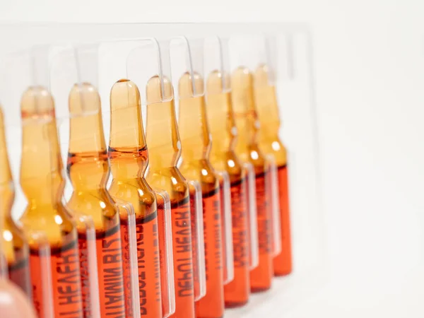 Ampoules for vitamin B12 injections. Injectable solution ampoules used to supplement vitamin B12. Close-up.