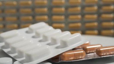 Close up with pills rotating. Pills and drugs. Medicine, pills and tablets with blister packs turning. Close-up View of Package with Medical Pills. High quality 4k footage