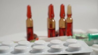 Close up with pills rotating. Pills and drugs. Medicine, pills and tablets with blister packs turning. Close-up View of Package with Medical Pills. High quality 4k footage