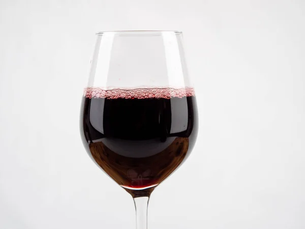 A glass of wine on a white background. Glass goblet with wine.