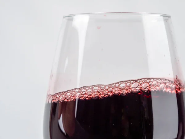 A glass of wine on a white background. Glass goblet with wine.