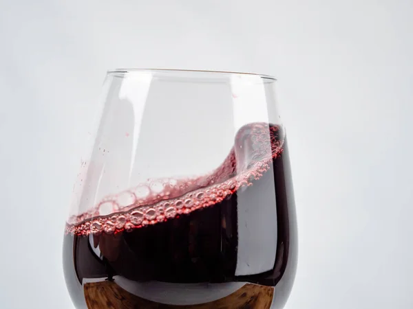 A glass of wine on a white background. Glass goblet with wine.